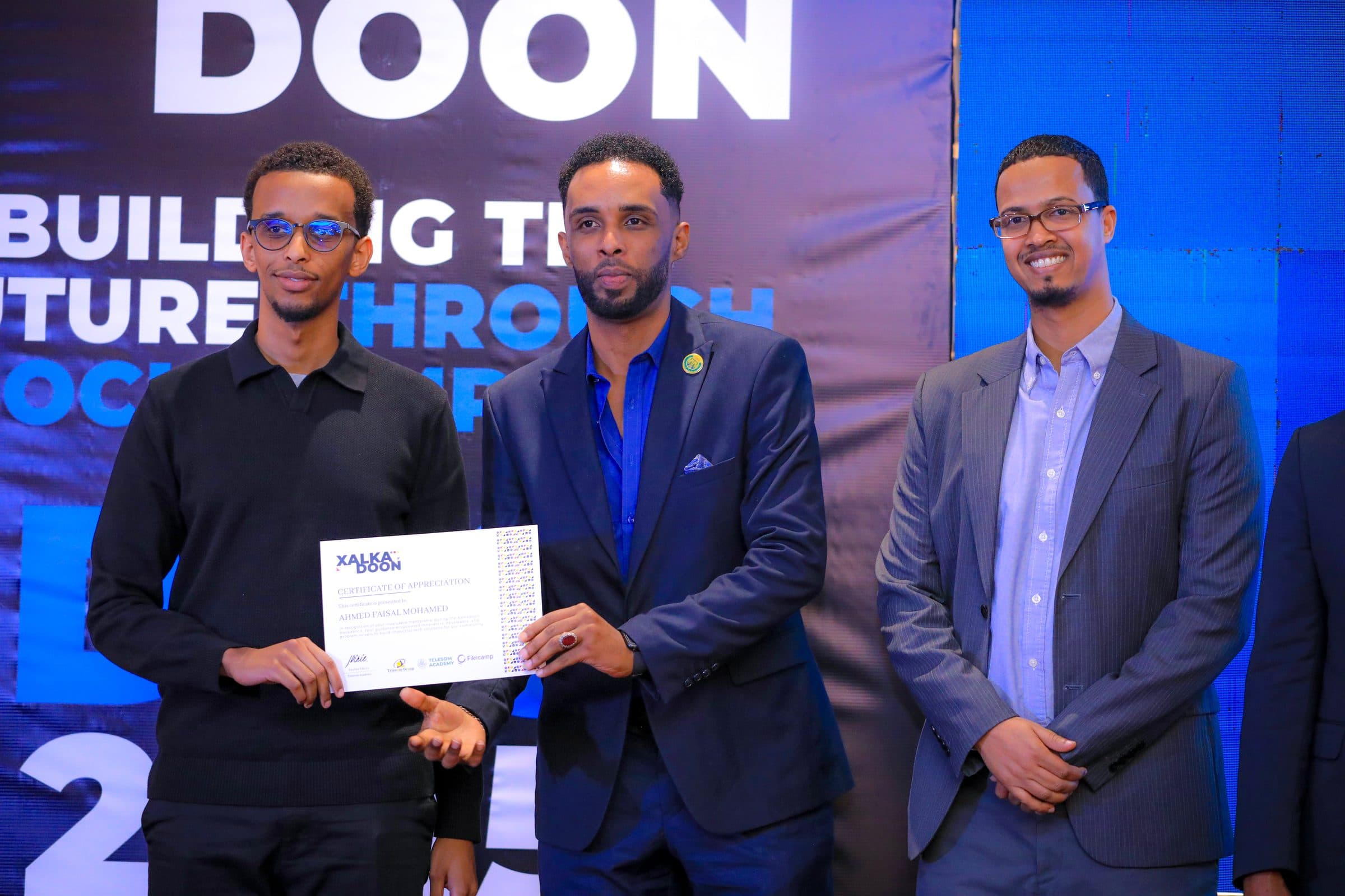 Faisal receiving a certificate of appreciation at Xalkadoon 2025