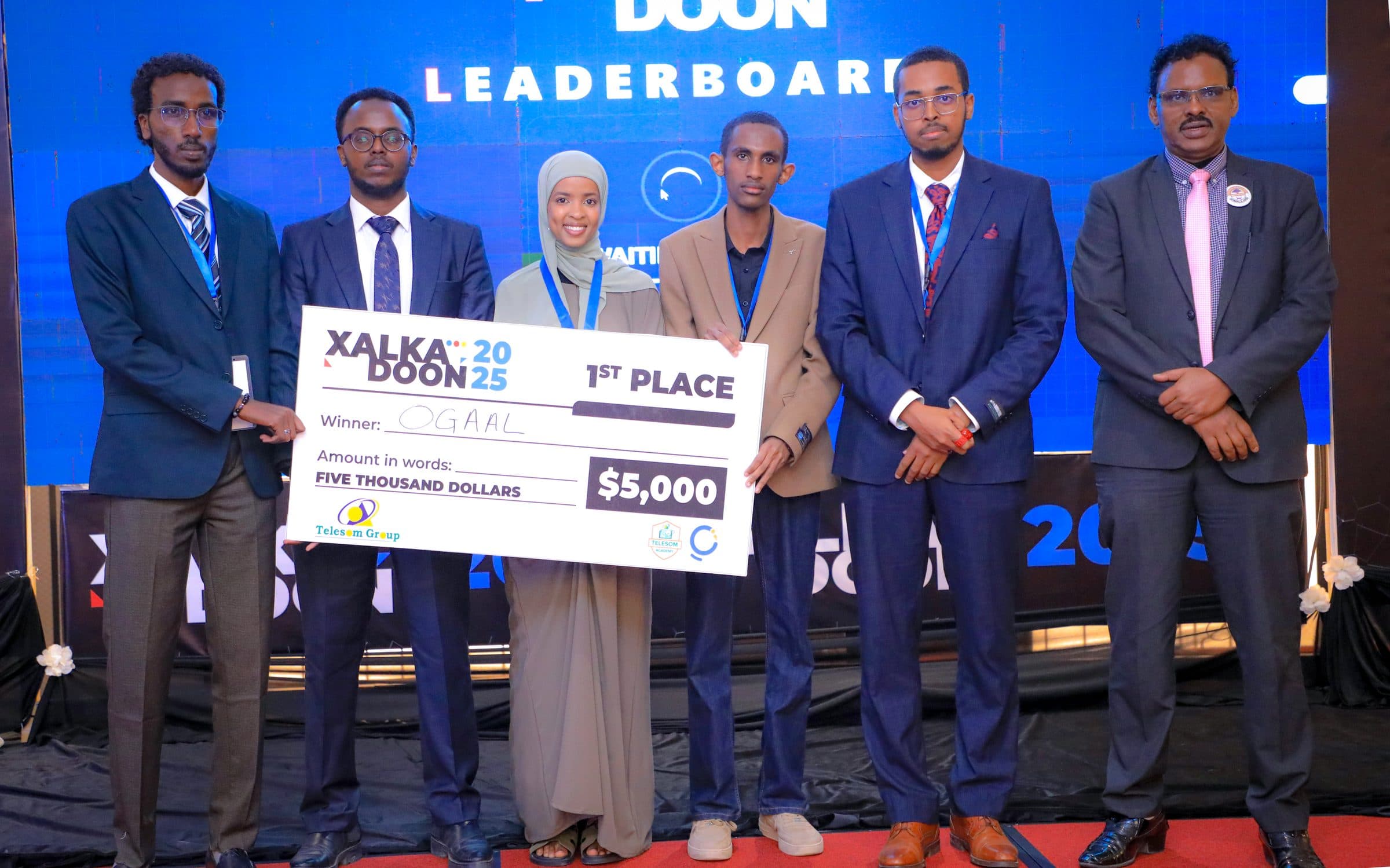 Ogaal receiving the $5,000 first place prize at Xalkadoon 2025