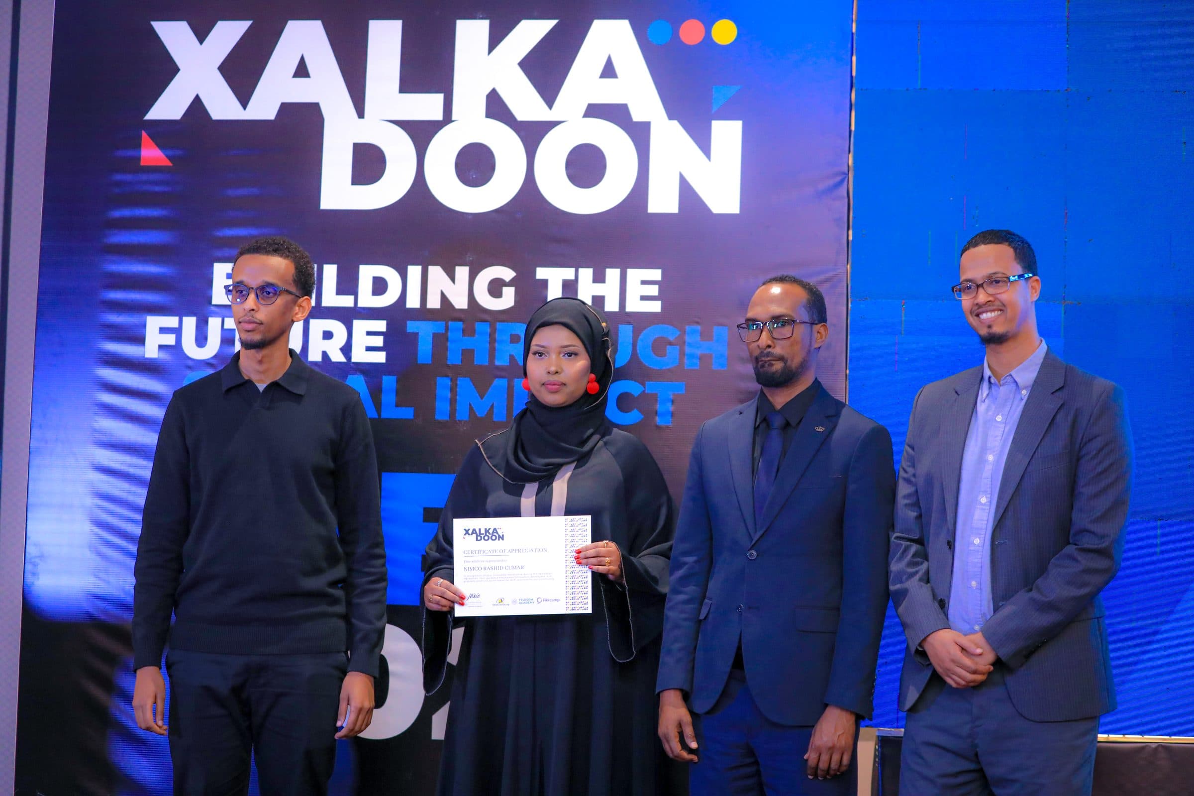 Nimo receiving a certificate of appreciation at Xalkadoon 2025