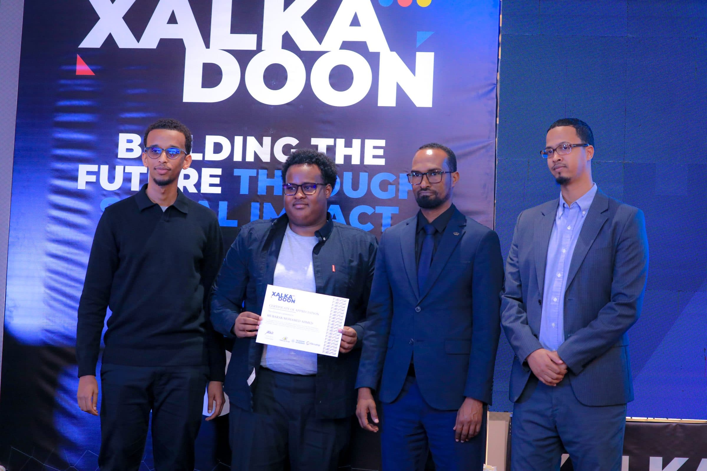Shabel receiving a certificate of appreciation at Xalkadoon 2025