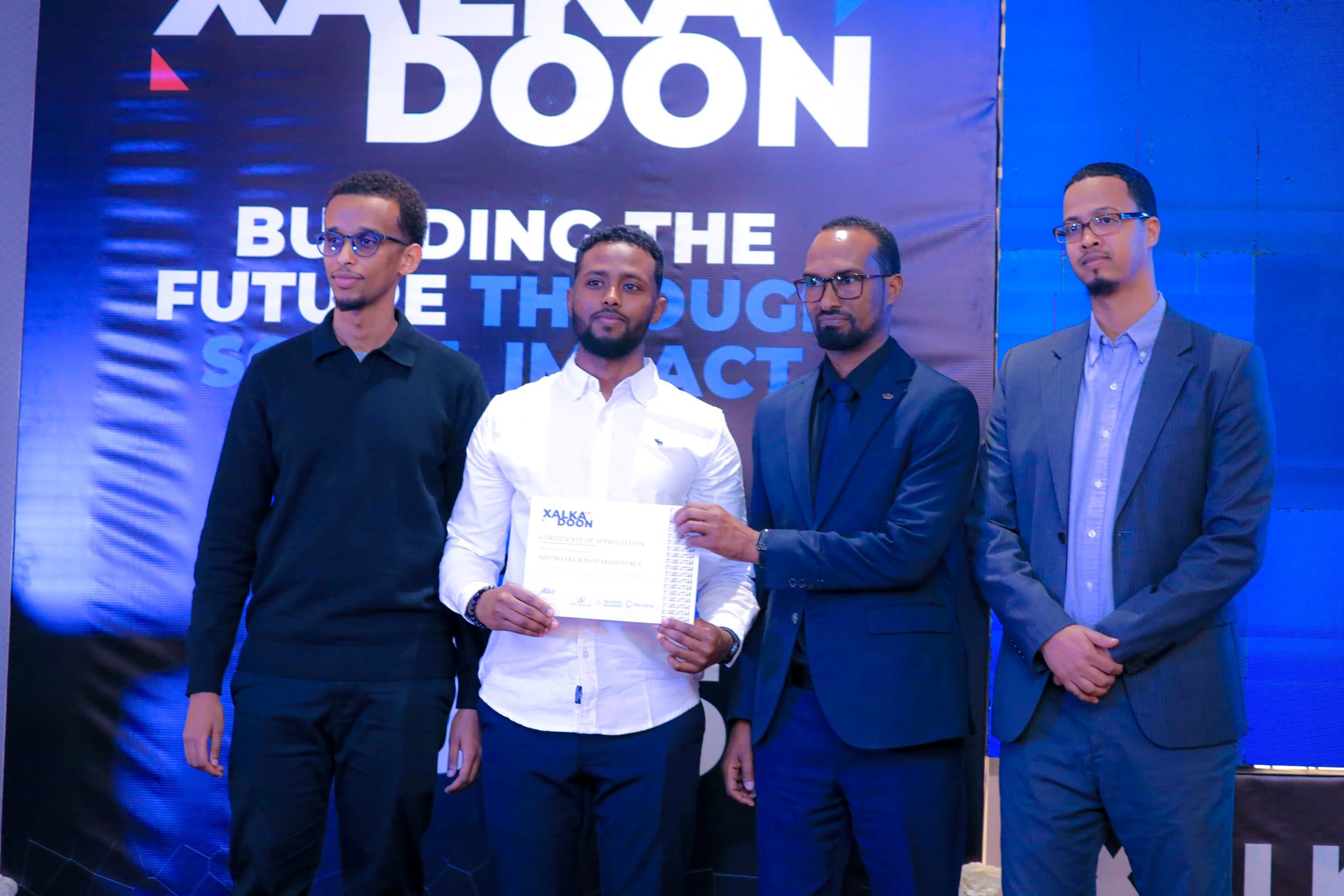 Shaku receiving a certificate of appreciation at Xalkadoon 2025